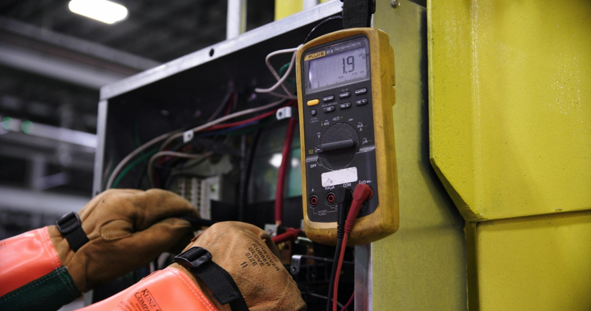 Technician inspecting electrical panel at Amazon Data Center