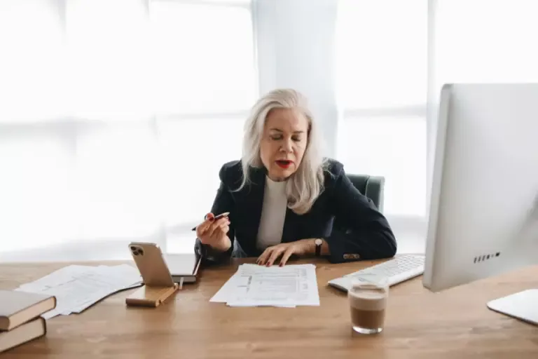 Intern reviewing ESG investment reports with a senior banker in a New York office